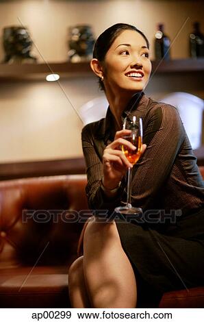 Woman with champagne glass, smiling, looking away View Large Photo Image Stock Photo - Woman with champagne glass, smiling, looking away. Fotosearch