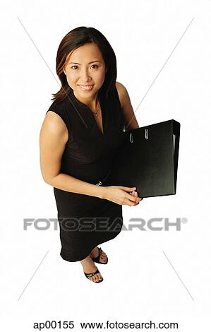 Woman with document binder, looking up at camera View Large Photo Image Stock Photography - Woman with document binder, looking up at camera. Fotosearch