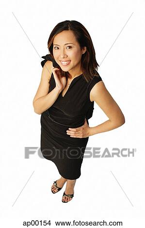 Woman with hand on hip, looking up at camera View Large Photo Image Picture - Woman with hand on hip, looking up at camera. Fotosearch