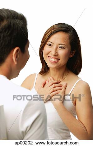 Woman with hands on chest, facing man View Large Photo Image Stock Image - Woman with hands on chest, facing man. Fotosearch