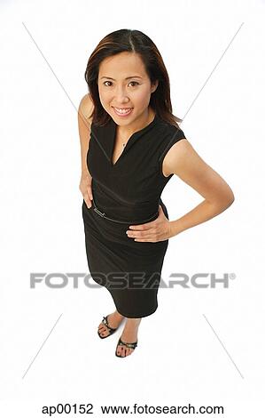 Woman with hands on hips, looking up at camera View Large Photo Image Stock Image - Woman with hands on hips, looking up at camera. Fotosearch