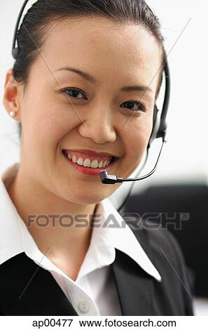 Stock Photo - Woman with headset, looking at camera. Fotosearch