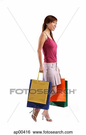 Stock Photograph - Woman with shopping bags. Fotosearch