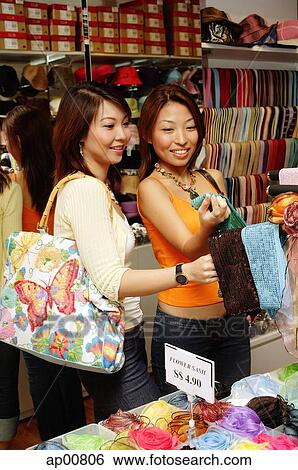 Women shopping, looking at scarves View Large Photo Image Stock Photograph - Women shopping, looking at scarves. Fotosearch