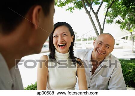 Stock Photo - Young adults laughing, portrait. Fotosearch
