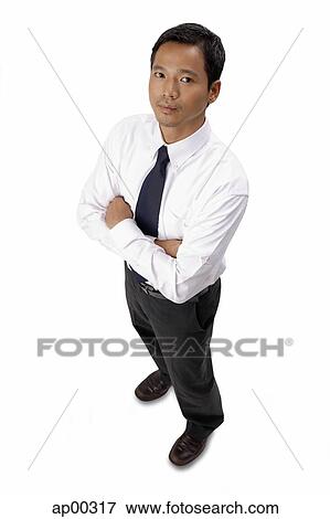 Young executive, arms crossed, looking at camera View Large Photo Image Stock Photo - Young executive, arms crossed, looking at camera. Fotosearch