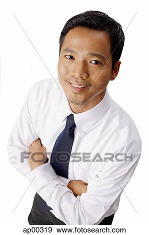 Young executive, looking at camera, arms crossed View Large Photo Image Stock Photo - Young executive, looking at camera, arms crossed. Fotosearch