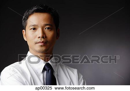 Stock Photography - Young executive, looking at camera, portrait. Fotosearch