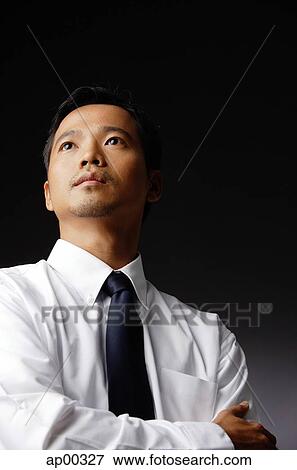 Young executive, looking away, arms crossed View Large Photo Image Stock Photo - Young executive, looking away, arms crossed. Fotosearch