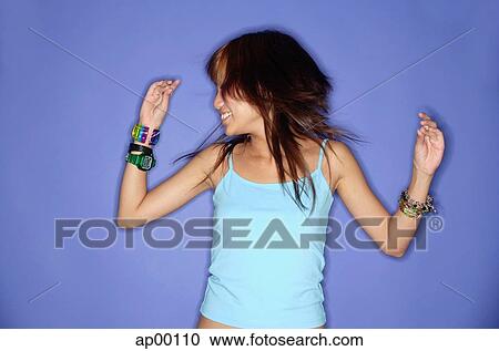 Stock Image - Young woman against blue background. Fotosearch