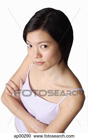 Young woman looking at camera, arms crossed View Large Photo Image Stock Image - Young woman looking at camera, arms crossed. Fotosearch