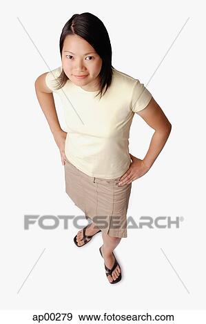 Young woman looking at camera, hands on hips View Large Photo Image Stock Photo - Young woman looking at camera, hands on hips. Fotosearch