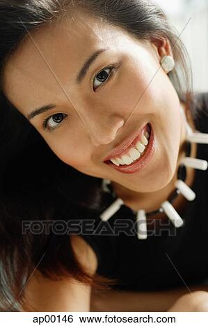 Young woman looking at camera, head shot View Large Photo Image Stock Photograph - Young woman looking at camera, head shot. Fotosearch