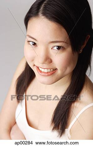 Picture - Young woman looking at camera. Fotosearch