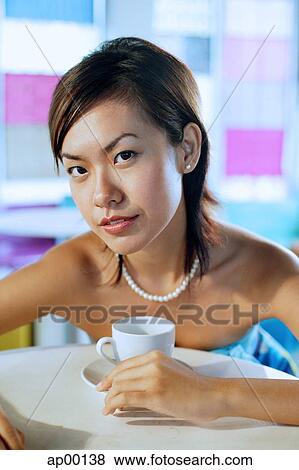 Young woman looking at camera, portrait View Large Photo Image Stock Photo - Young woman looking at camera, portrait. Fotosearch