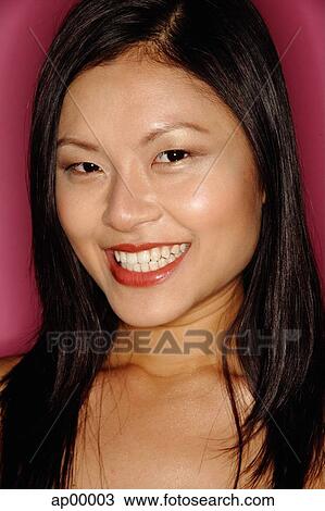 Young woman looking at camera, smiling, portrait View Large Photo Image Stock Image - Young woman looking at camera, smiling, portrait. Fotosearch
