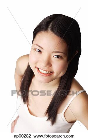 Young woman looking at camera, smiling View Large Photo Image Stock Image - Young woman looking at camera, smiling. Fotosearch