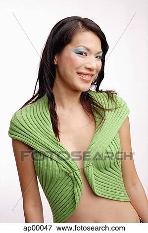 Stock Photo - Young woman, looking at camera, smiling. Fotosearch