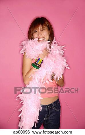 Stock Photograph - Young woman looking at camera, wearing feather boa. Fotosearch