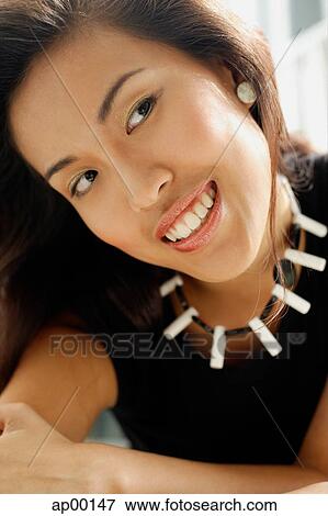 Young woman looking away, head shot View Large Photo Image Stock Photo - Young woman looking away, head shot. Fotosearch