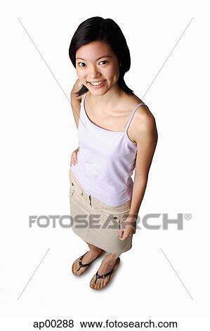 Young woman looking up at camera, hand on hip View Large Photo Image Stock Photo - Young woman looking up at camera, hand on hip. Fotosearch