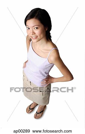 Young woman smiling at camera, hands on hips View Large Photo Image Stock Photo - Young woman smiling at camera, hands on hips. Fotosearch