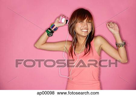 Young woman smiling, using headphones View Large Photo Image Stock Photo - Young woman smiling, using headphones. Fotosearch