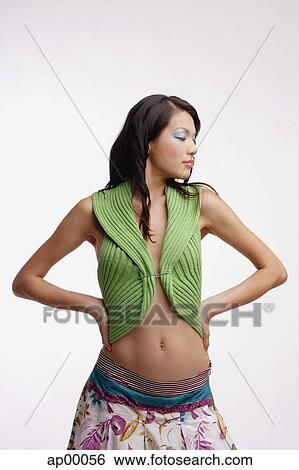 Young woman, standing, hands on hip, looking away View Large Photo Image Stock Photograph - Young woman, standing, hands on hip, looking away. Fotosearch