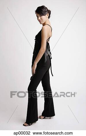 Young woman standing, looking at camera, portrait View Large Photo Image Stock Image - Young woman standing, looking at camera, portrait. Fotosearch