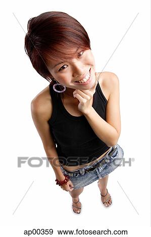 Young woman with hand on chin, looking up at camera View Large Photo Image Stock Photo - Young woman with hand on chin, looking up at camera. Fotosearch