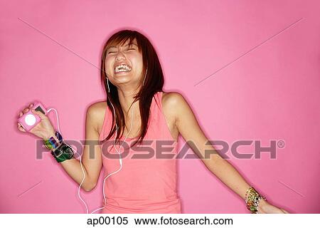 Young woman with mp3 player, laughing View Large Photo Image Stock Photography - Young woman with mp3 player, laughing. Fotosearch