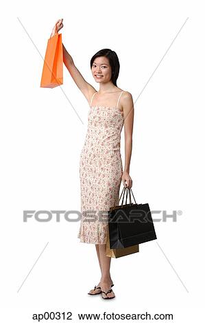 Stock Image - Young woman with shopping bags, portrait. Fotosearch
