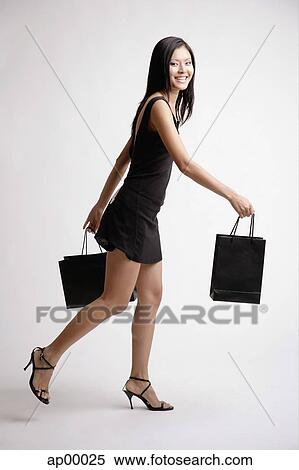 Young woman with shopping bags View Large Photo Image Stock Photography - Young woman with shopping bags. Fotosearch