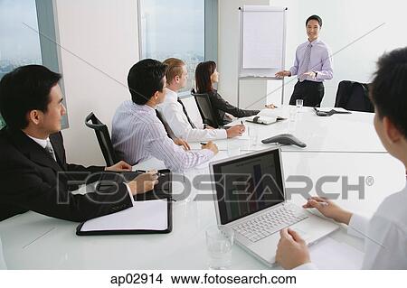 Executives in a presentation meeting View Large Photo Image Stock Photo - Executives in a presentation meeting . Fotosearch - Search Stock Images, Mural Photographs, Pictures, and Clipart Photos