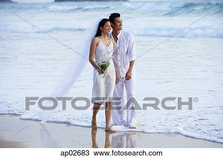 Bride and groom walking on beach View Large Photo Image Stock Image - Bride and groom walking on beach. Fotosearch