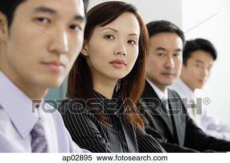 Business people in a row, looking at camera, head shot View Large Photo Image Stock Photography - Business people in a row, looking at camera, head shot . Fotosearch