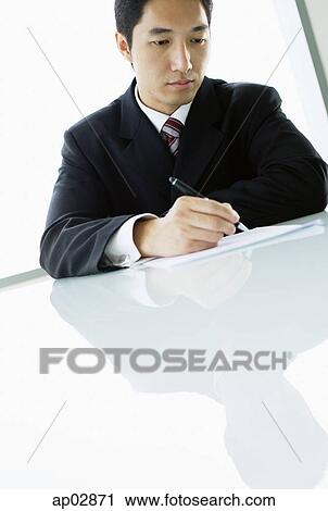 Businessman holding pen, writing View Large Photo Image Stock Image - Businessman holding pen, writing . Fotosearch