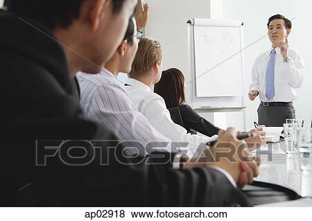 Businessman presenting to other executives View Large Photo Image Stock Photo - Businessman presenting to other executives . Fotosearch