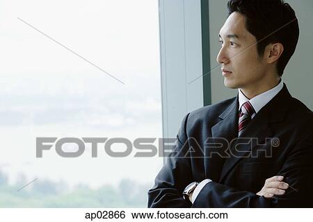 Businessman standing next to window View Large Photo Image Stock Photograph - Businessman standing next to window . Fotosearch