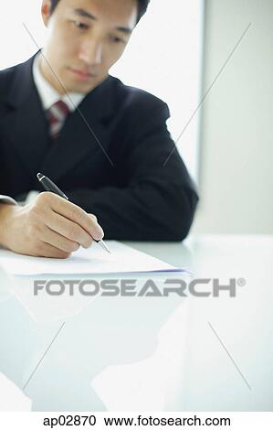 Businessman writing on paper View Large Photo Image Stock Image - Businessman writing on paper . Fotosearch
