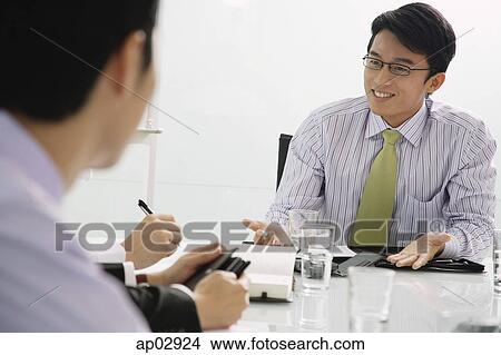 Businessmen having a discussion View Large Photo Image Picture - Businessmen having a discussion. Fotosearch
