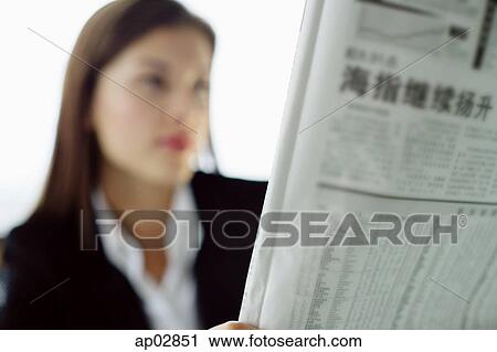 Businesswoman reading newspaper View Large Photo Image Stock Image - Businesswoman reading newspaper . Fotosearch