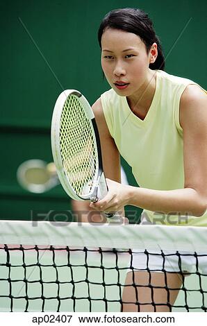 Close up of a woman playing tennis View Large Photo Image Stock Photo - Close up of a woman playing tennis . Fotosearch