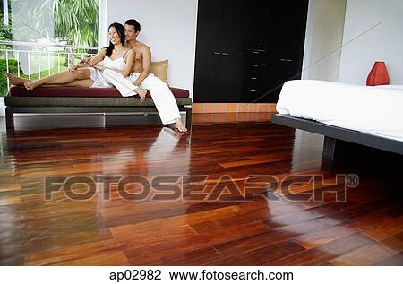 Couple at home in bedroom, sitting on daybed View Large Photo Image Stock Image - Couple at home in bedroom, sitting on daybed . Fotosearch