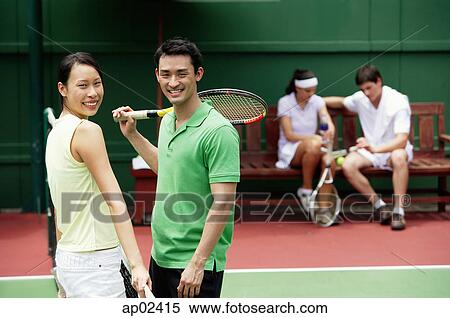 Couple at tennis court, looking at camera, smiling View Large Photo Image Stock Photography - Couple at tennis court, looking at camera, smiling . Fotosearch