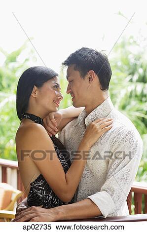 Stock Photography - Couple embracing, looking at each other . Fotosearch