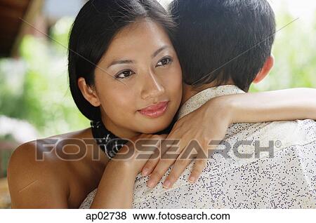 Couple embracing, woman resting head on mans shoulder View Large Photo Image Stock Photo - Couple embracing, woman resting head on mans shoulder . Fotosearch