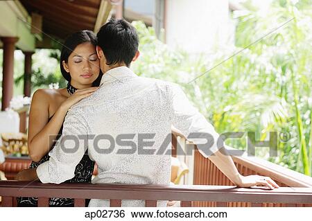 Couple embracing, woman resting head on mans shoulder, eyes closed View Large Photo Image Stock Photograph - Couple embracing, woman resting head on mans shoulder, eyes closed . Fotosearch