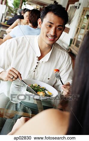 Couple having a meal in restaurant View Large Photo Image Stock Image - Couple having a meal in restaurant . Fotosearch