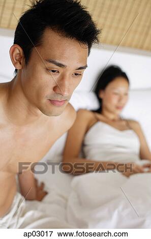 Couple in bed, focus on the man View Large Photo Image Stock Photo - Couple in bed, focus on the man. Fotosearch